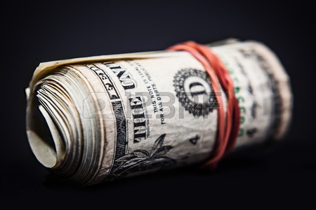 25720442-money-roll-close-up-in-dark-background